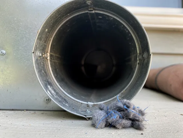 Brookfield Dryer Vent Cleaning technician using specialized equipment to clear severe dryer vent blockage in Brookfield